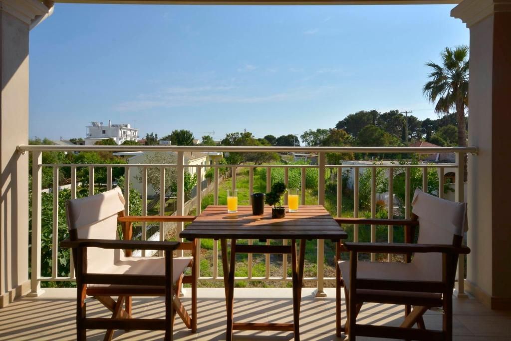 Balcony with table and chairs overlooking the greenery